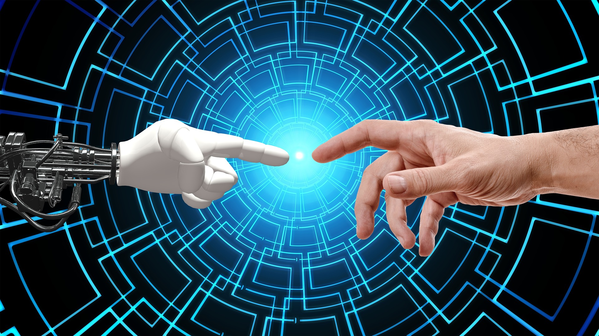 Human and robot hands touching.